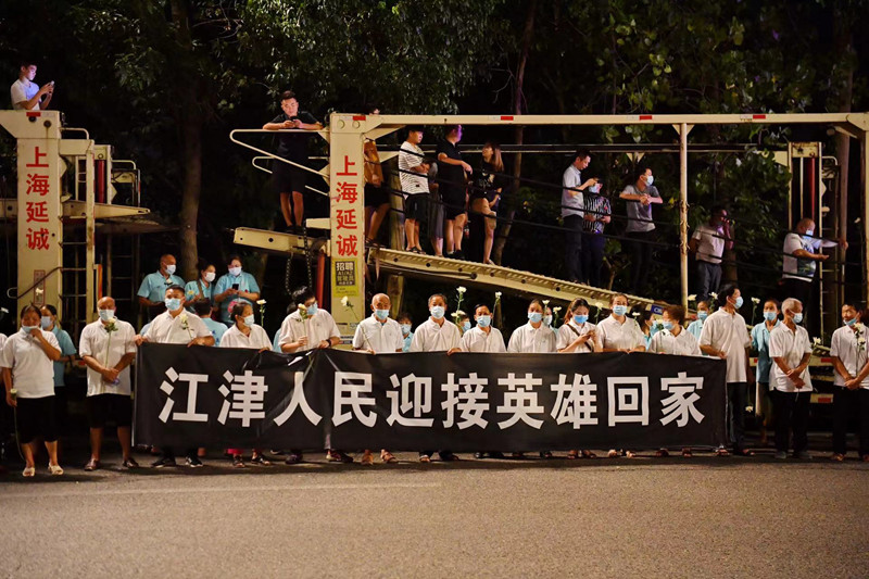 當地群眾自發迎接英雄回家。賀奎攝