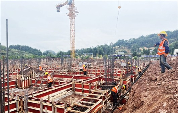 九隆現代中藥有限公司施工現場一派忙碌，工人在綁扎鋼筋、制作安裝模板。李佳遙攝