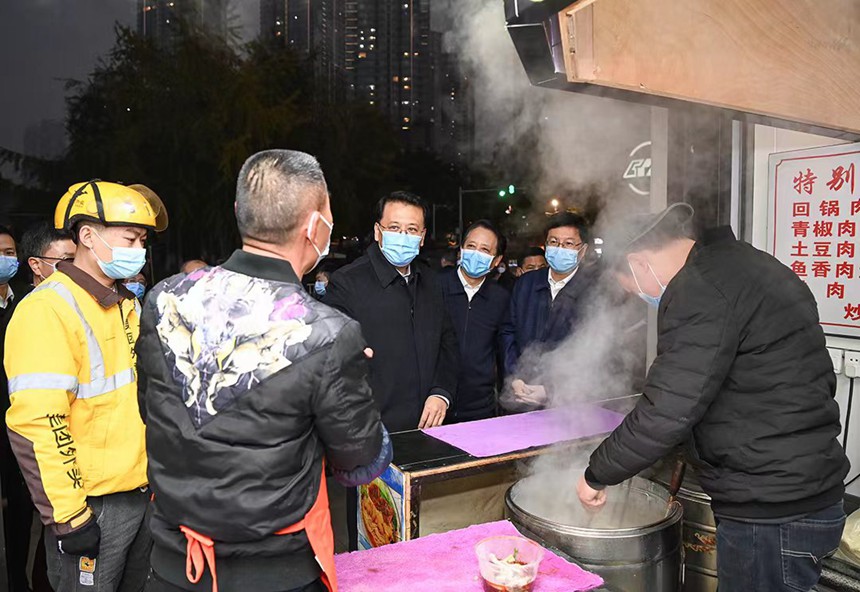 12月12日下午，在解放碑中央商務區，市委書記袁家軍同面館老板交流。記者 蘇思 攝/視覺重慶