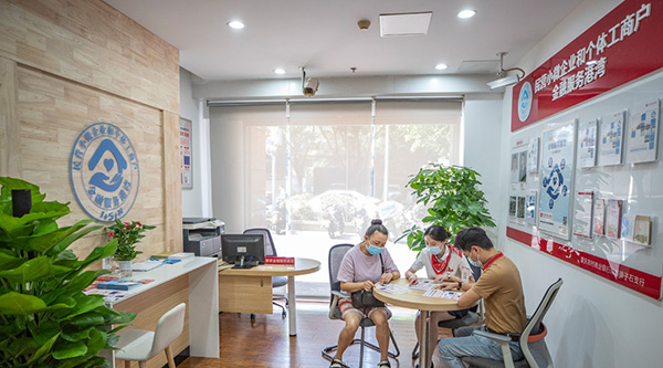 重慶農商行南岸彈子石支行金融服務港灣的工作人員為前來咨詢的商戶介紹普惠金融貸款相關政策和產品。重慶農商行供圖