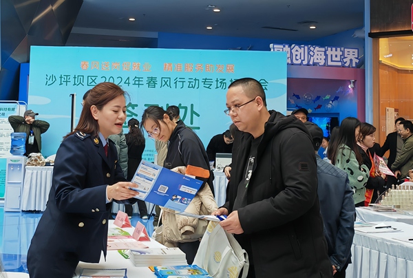 在沙坪壩區“2024年春風行動專場招聘會”現場，稅務人員為招聘企業和求職者講解稅費政策。陳賽亞攝