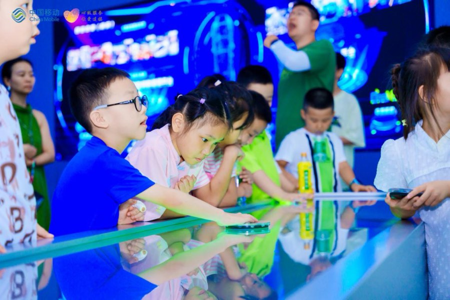 展廳里孩子們操作物聯網應用設施。重慶移動供圖