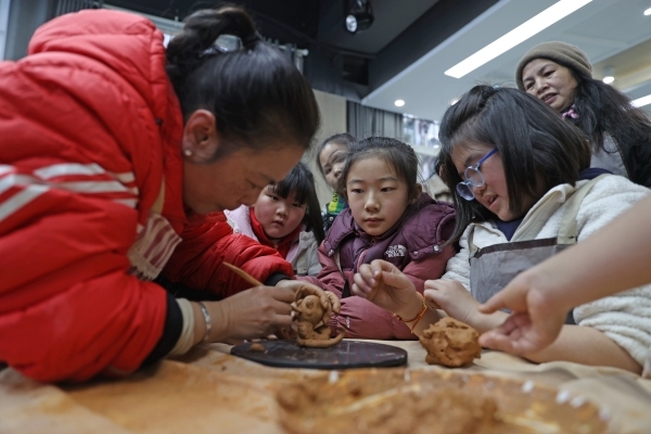 參加“童心筑夢·快樂成長”七彩假期公益托管班的孩子們正在學習陶藝制作。趙勇攝