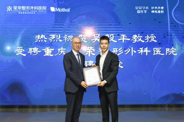 李昕昊（右）為特聘教授吳毅平頒發聘書。重慶星榮整形外科醫院供圖
