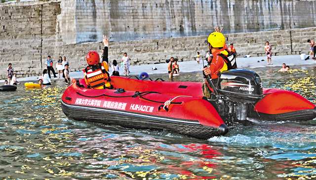七月三十一日晚，方舟救援隊隊員駕沖鋒舟示意市民回到岸邊。記者 張錦輝 攝\視覺重慶