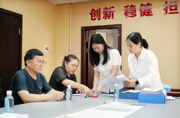 明月山擔保公司工作人員（右）正在為客戶辦理業務。向成國攝