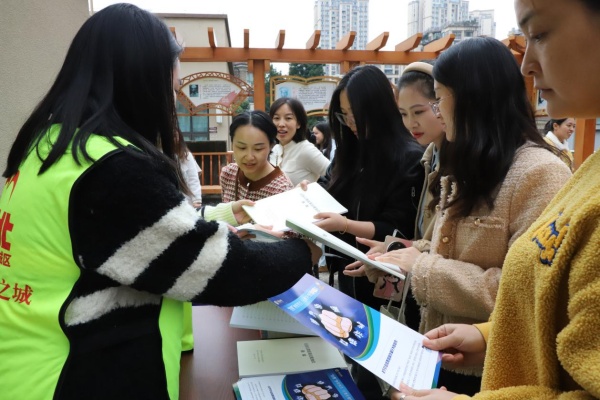 志愿者向居民發放宣傳資料。潘瑞攝